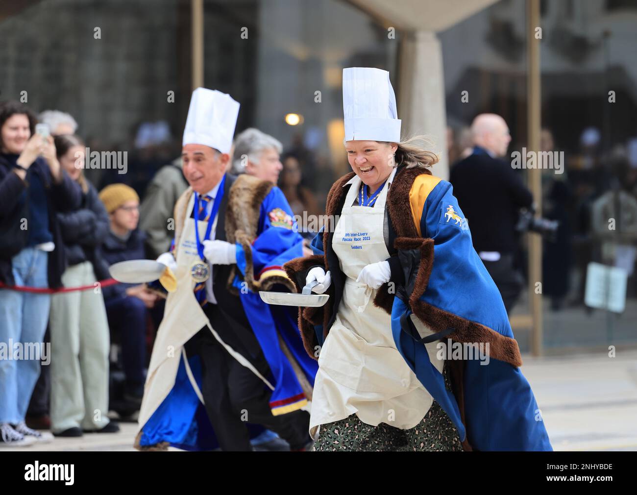 The quirky Inter Livery Pancake Race hosted by the Worshipful Company of Poulters, at Guildhall Yard, for Shrove Tuesday, 2023, in the Square Mile, London, UK Stock Photo