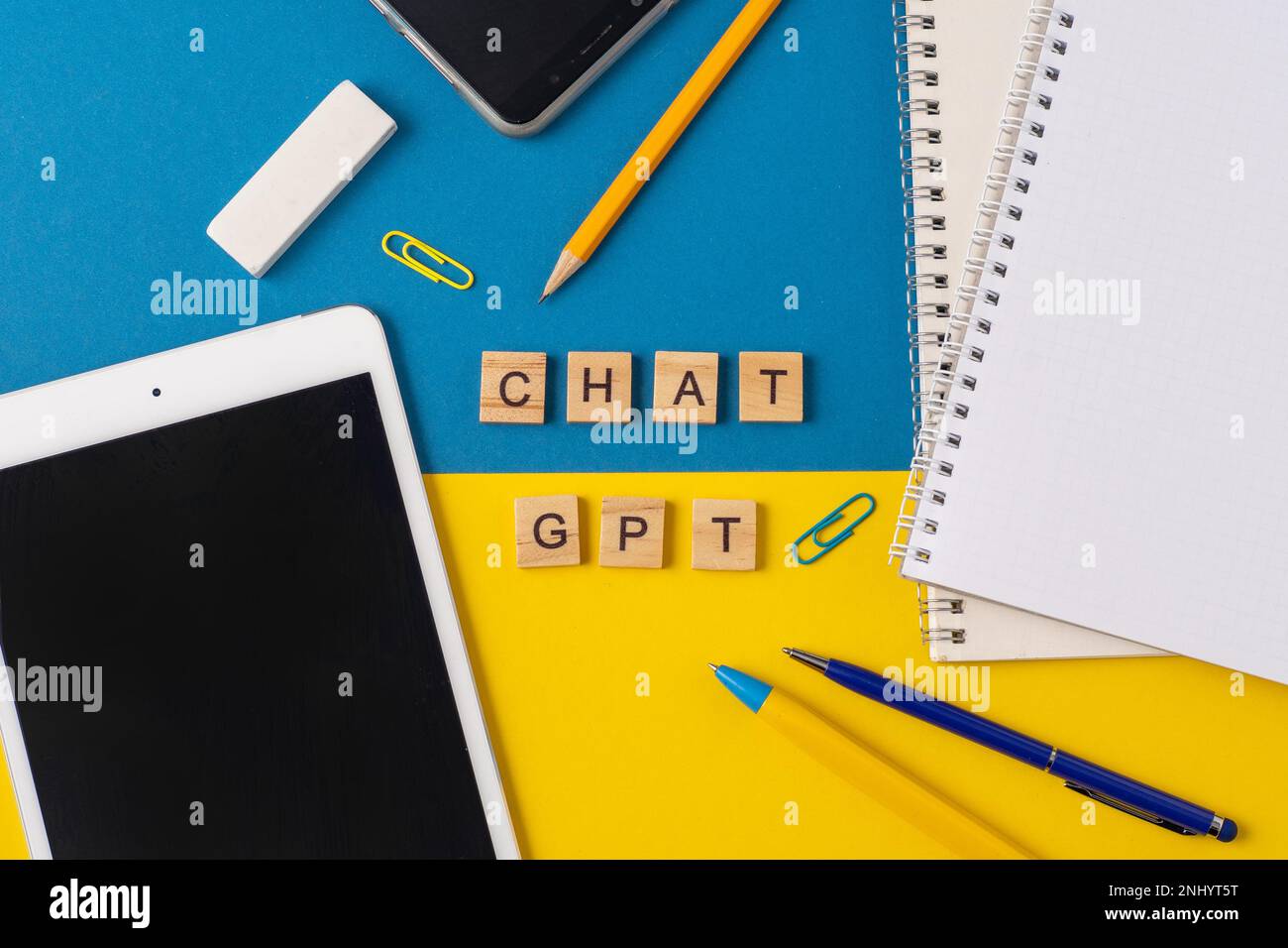 Work and study background with the help of a chatGPT bot. Words in wooden letters. Table top view with open notebook copy space. Chat GPT for working and creating Stock Photo
