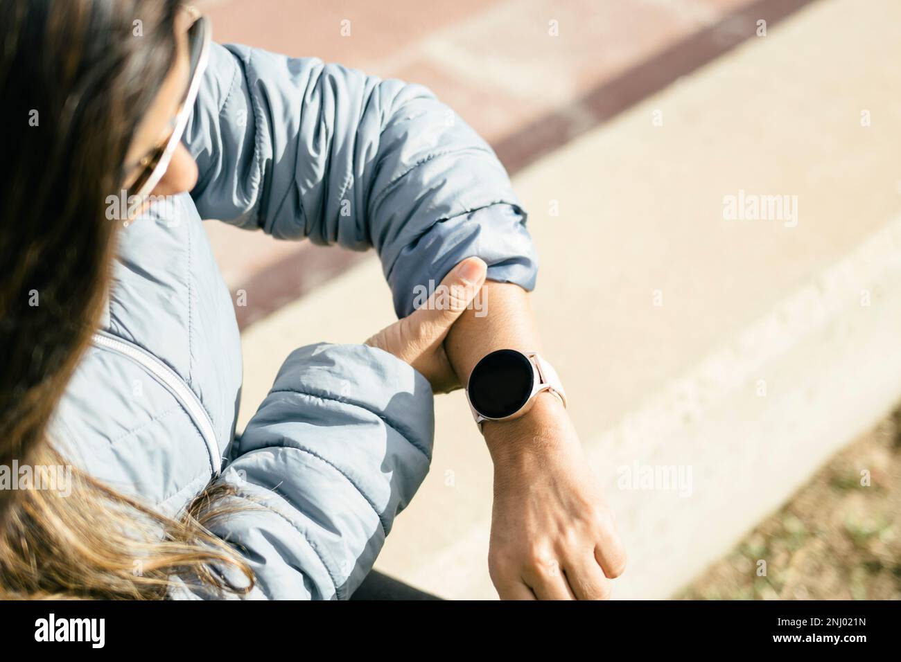 Latina Woman Checking Heart Rate on Smart Watch Stock Photo