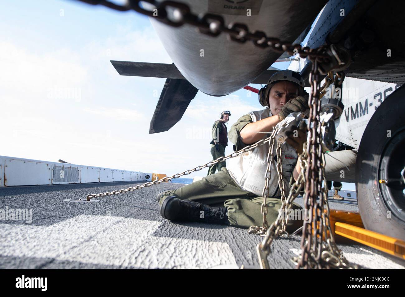 220803-N-FO865-4071    PACIFIC OCEAN (Aug 3, 2022) – U.S. Marine Corps SSgt. Jose Legorreta, ties down a CH-53E Super Stallion helicopter assigned to Marine Heavy Helicopter Squadron (HMH) 465, to the flight deck of amphibious transport dock ship USS John P. Murtha (LPD 26), August 3. The 13th MEU is a key component of the larger U.S. Naval force and a critical enabler to maritime campaign. John P. Murtha, part of amphibious squadron (CPR) SEVEN, along with 13th Marine Expeditionary Unit (MEU), is currently underway conducting integrated training in U.S. 3rd Fleet to prepare for an upcoming de Stock Photo