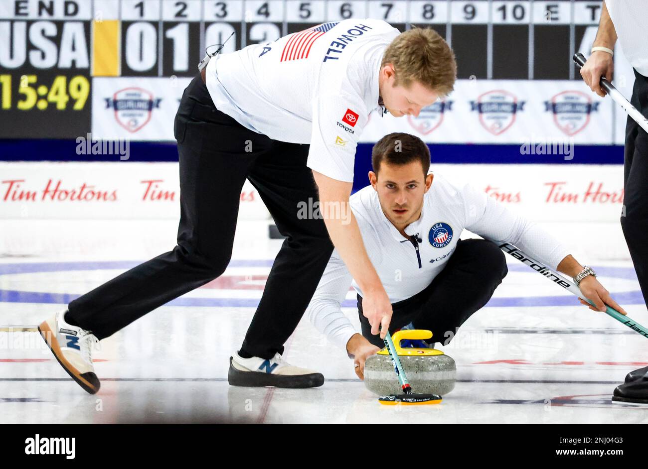 United States skip Korey Dropkin, right, and as lead Thomas Howell sweeps during semifinal playoff action against South Korea at the Pan Continental Curling Championships in Calgary, Alberta, Saturday, Nov