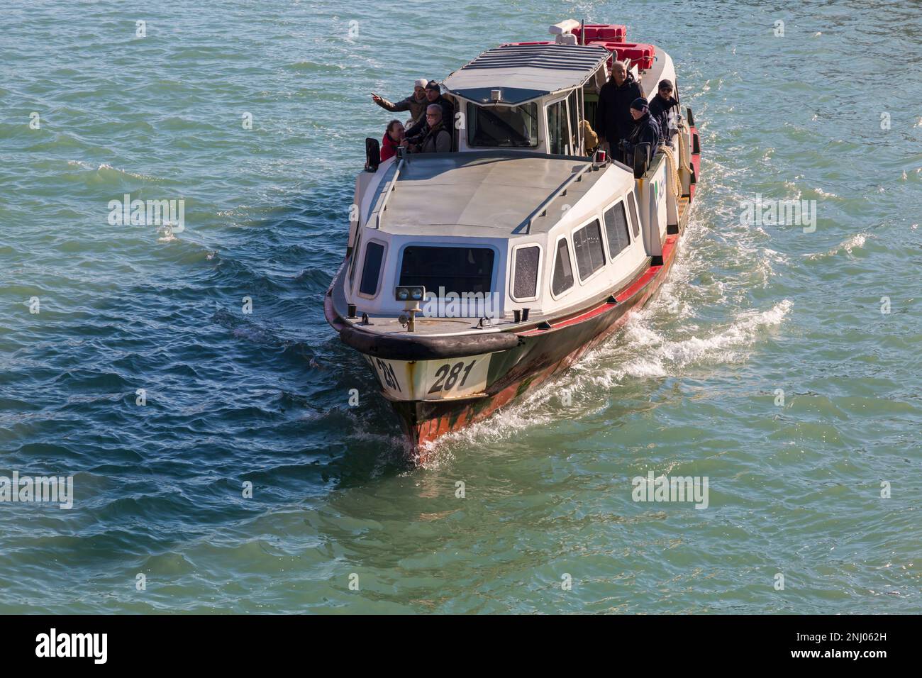 passengers travelling on water bus vaporetti vaporetto at Murano, Venice, Italy in February Stock Photo