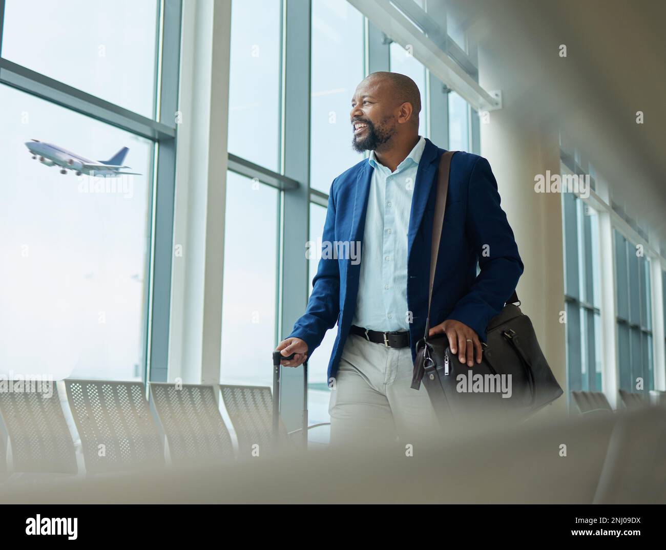 black-man-business-and-travel-at-airport-on-airplane-for-professional-trip-journey-or-flight-happy-manager-walking-with-suitcase-luggage-and-bag-2NJ09DX.jpg