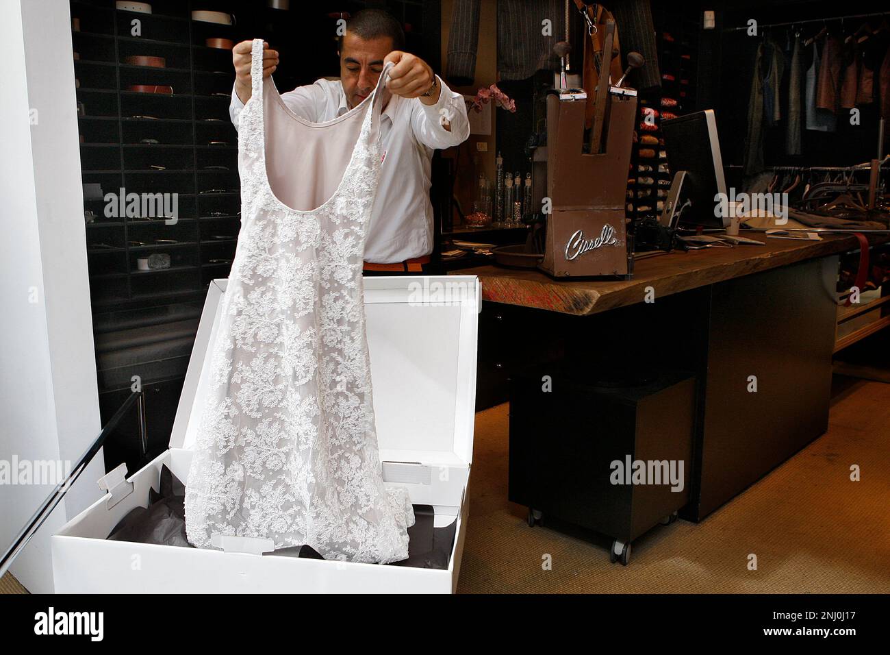 Designer Gus Harput packing a wedding dress he made in his Union Square  store in San Francisco, California, on Thursday, March 28, 2013. Made in  two days, and is packing it for, image size:1300x956