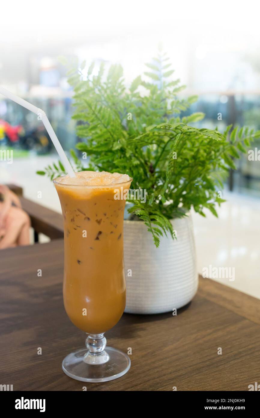 Milk tea or Teh Tarik on the wooden table. Stock Photo