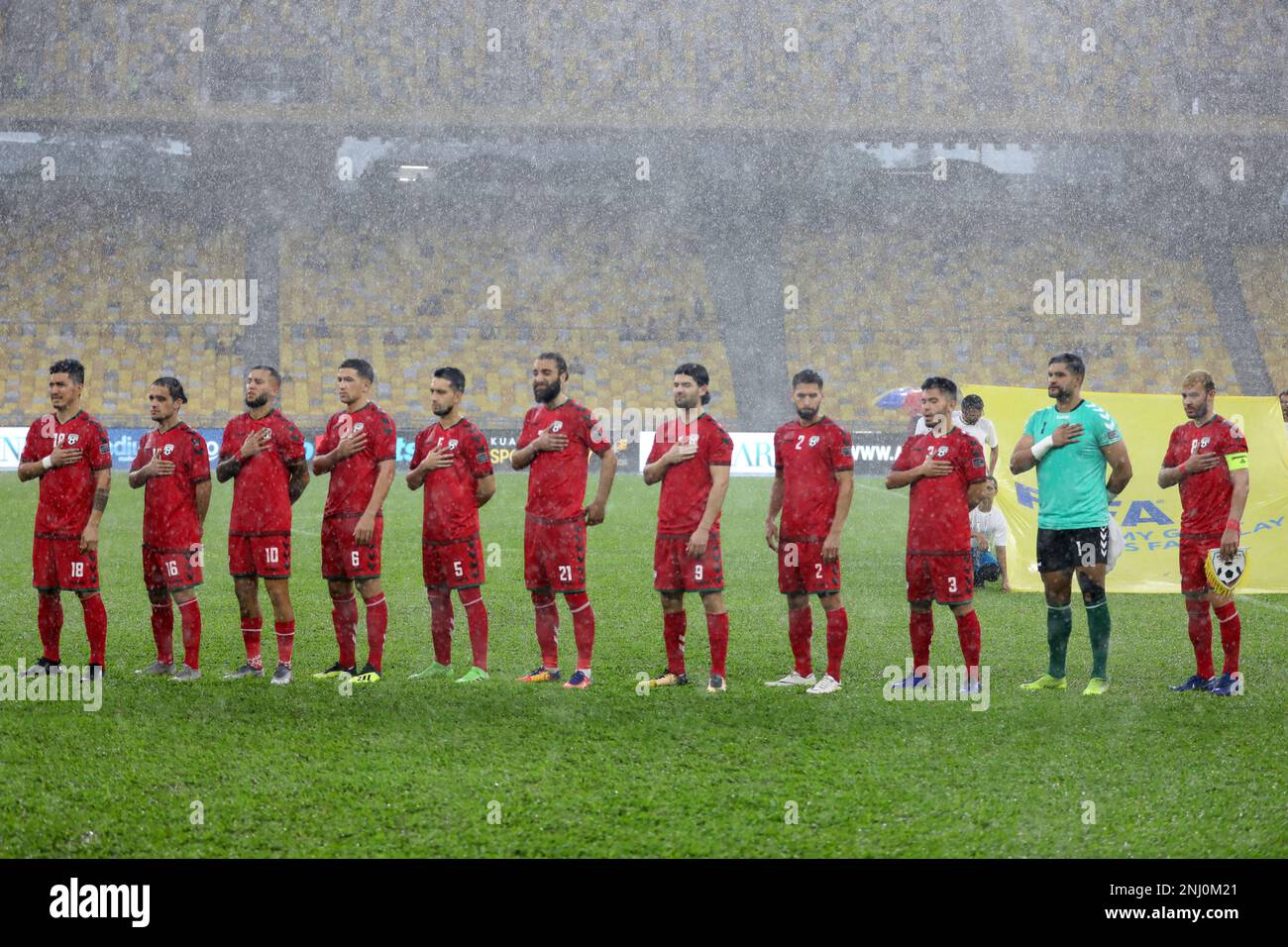 Afghanistan National Team standing for national anthem before their friendly game against Malaysia in Bukit Jalil National Stadium, Kuala Lumpur Stock Photo