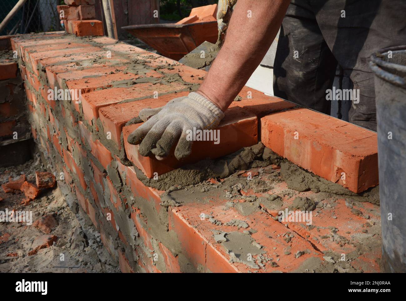 Industrial bricklayer photo. Bricklayer bricklaying brick wall. Masonry