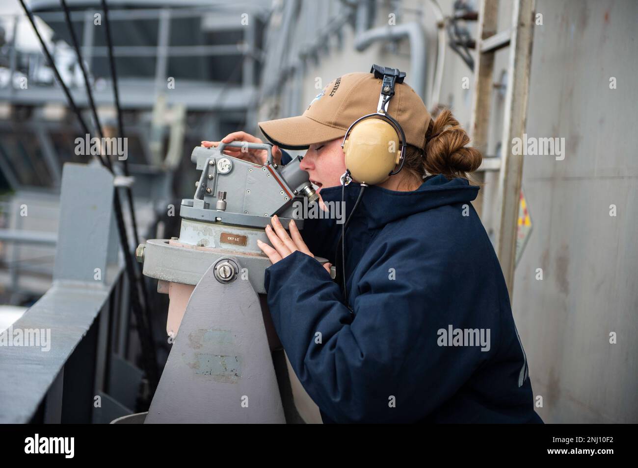 BREMERTON-NAVAL BASE KITSAP, Wash. (Aug. 4, 2022) – U.S. Navy Quartermaster 3rd Class Dakota Barnett, from Yuma, Ariz., looks through a telescopic alidade aboard the Nimitz-class aircraft carrier USS Theodore Roosevelt (CVN 71) as the ship exits dry dock, Aug. 4, 2022. Theodore Roosevelt is in a docking planned incremental availability at Puget Sound Naval Shipyard and Intermediate Maintenance Facility where the ship will receive scheduled maintenance and upgrades. Stock Photo