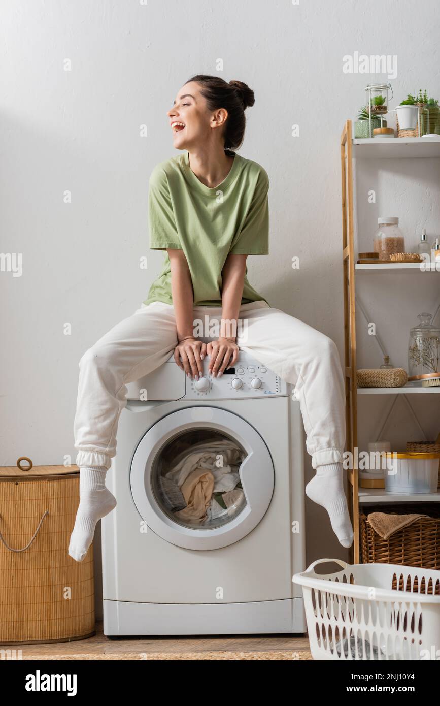 Sitting on washing machine in hi-res stock photography and images - Alamy