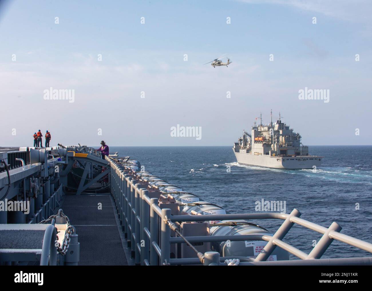 220804-N-OM737-1043  ATLANTIC OCEAN (August 4, 2022) The Wasp-class amphibious assault ship USS Bataan (LHD 5) pulls alongside the Dry Cargo Ammunition Ship USNS Medgar Evers (T-AKE 13) in preparation for a replenishment-at-sea, Aug. 4, 2022. Bataan is underway conducting deck landing qualifications and preparations for an upcoming Board of inspection and Survey evaluation. Stock Photo