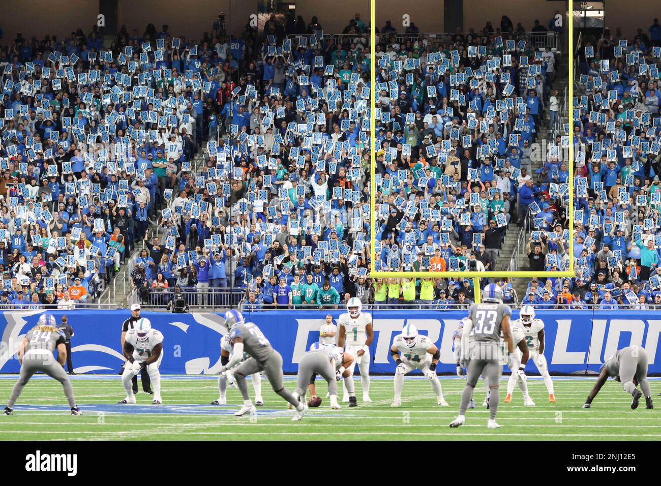 Detroit Lions fans hold up signs with the number 3 during a