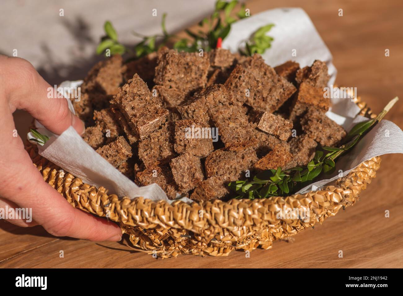 Homemade black rye cereal bread in a wicker basket in a traditional street food market, close up Stock Photo