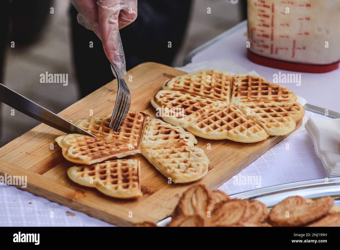Preparing waffle or waffles, dish made from leavened butter or dough that is cooked between two plates that are patterned to give a characteristic siz Stock Photo