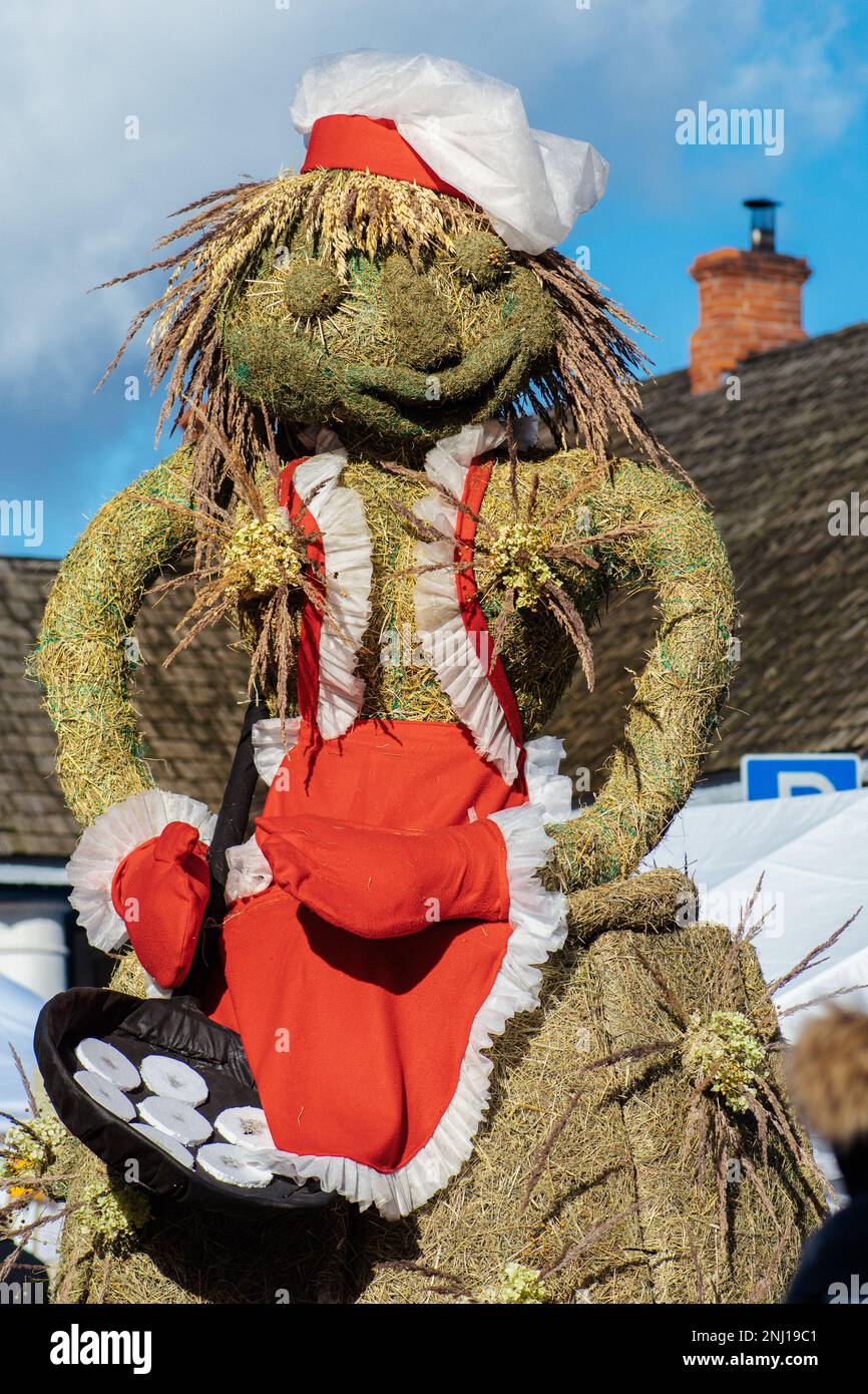 Traditional puppet made of straw preparing pancakes in Lithuania during Uzgavenes, a Lithuanian folk festival during Carnival Stock Photo