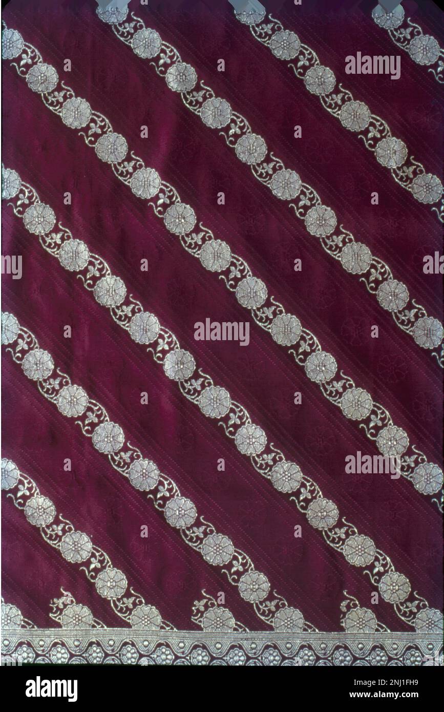 A Banarasi sari is a sari made in Varanasi, an ancient city which is also called Benares (Banaras). The saris are among the finest saris in India and are known for their gold and silver brocade or zari, fine silk and opulent embroidery. There are four varieties of Banarasi sarees - the pure silk sarees (katan), Organza (kora) with zari, georgette, and shattir sarees. Stock Photo