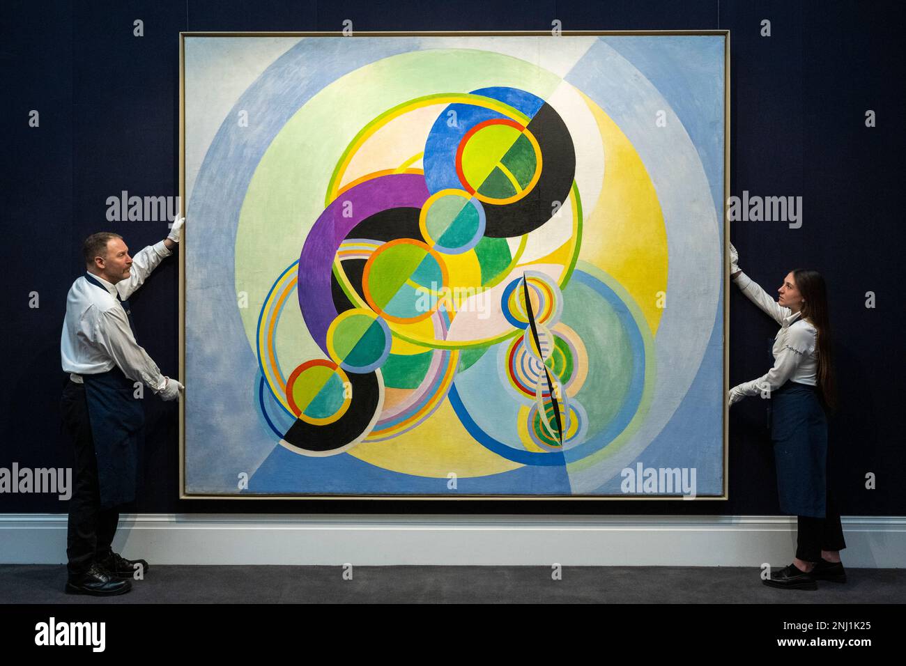 London, UK.  22 February 2023. Technicians present 'Rythme circulaire' by Robert Delaunay (Est. £7,000,000 - 10,000,000)at a preview of highlights from Sotheby’s upcoming Modern & Contemporary Evening sale featuring works by Kandinsky, Picasso, Richter and Munch.  The sale takes place at Sotheby’s New Bond Street galleries on 1 March 2023. Credit: Stephen Chung / Alamy Live News Stock Photo