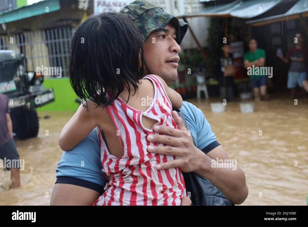 Philippine Rescuer Model In this photo provided by the Philippine Coast Guard, a rescuer carries ...