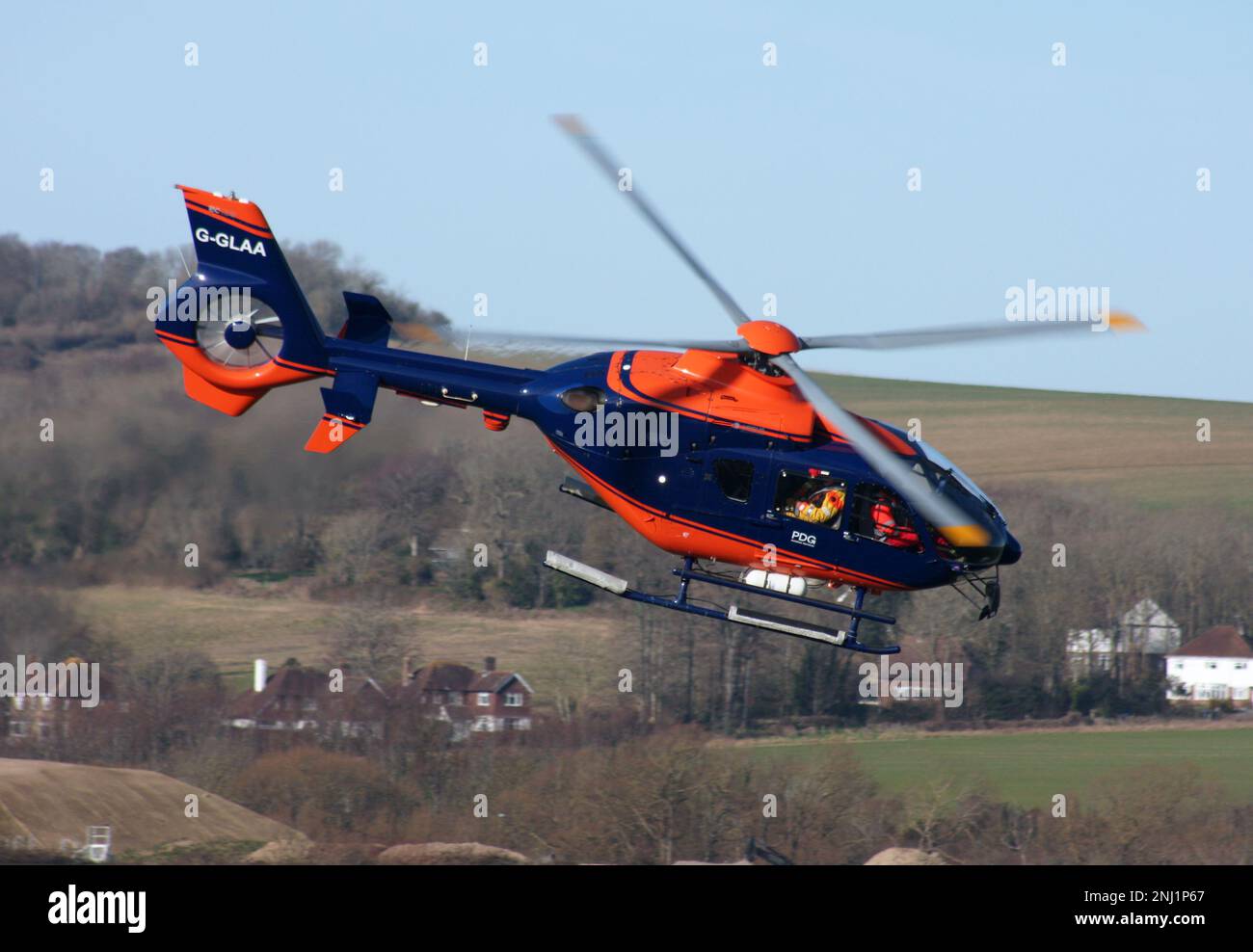 A Eurocopter EC 135T2+ helicopter of PDG Helicopters departing Brighton City Airport Sussex England Stock Photo