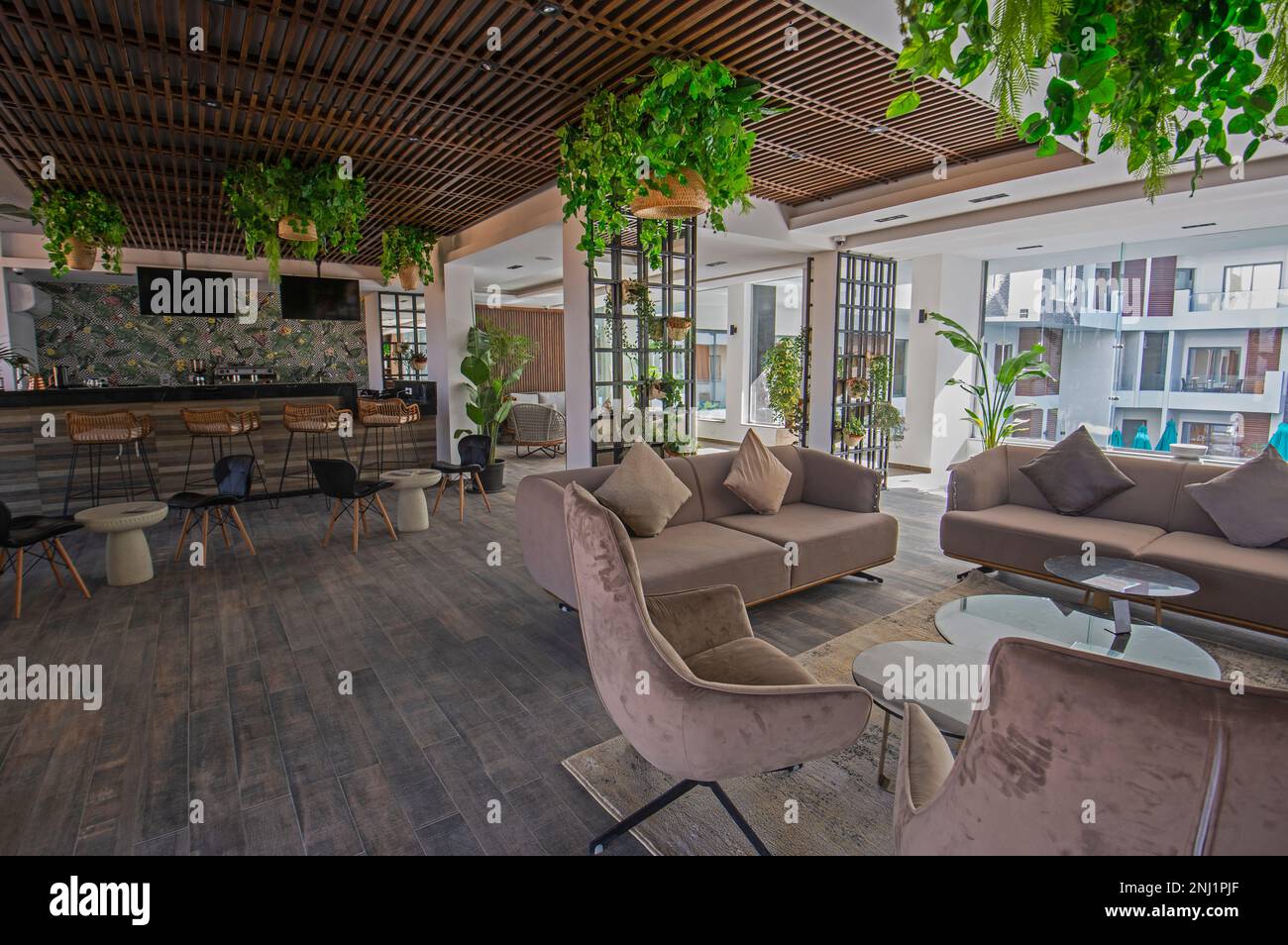 Interior design of a luxury hotel resort lobby reception area with seating and bar area Stock