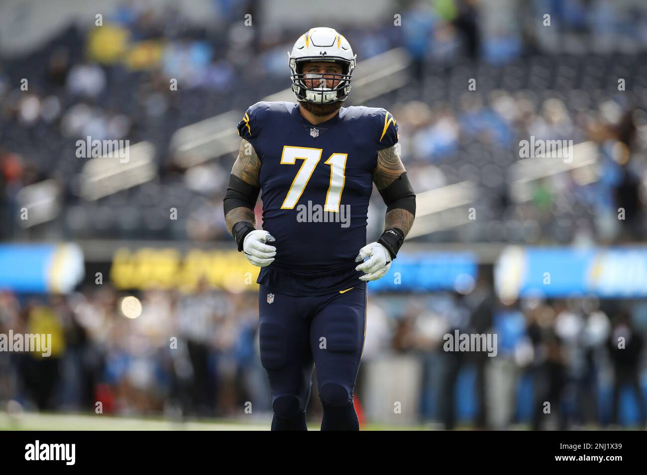 Los Angeles Chargers quarterback Justin Herbert (10) adjusts his helmet as  he warms up before an NFL football game against the Seattle Seahawks Sunday,  Oct. 23, 2022, in Inglewood, Calif. (AP Photo/Marcio