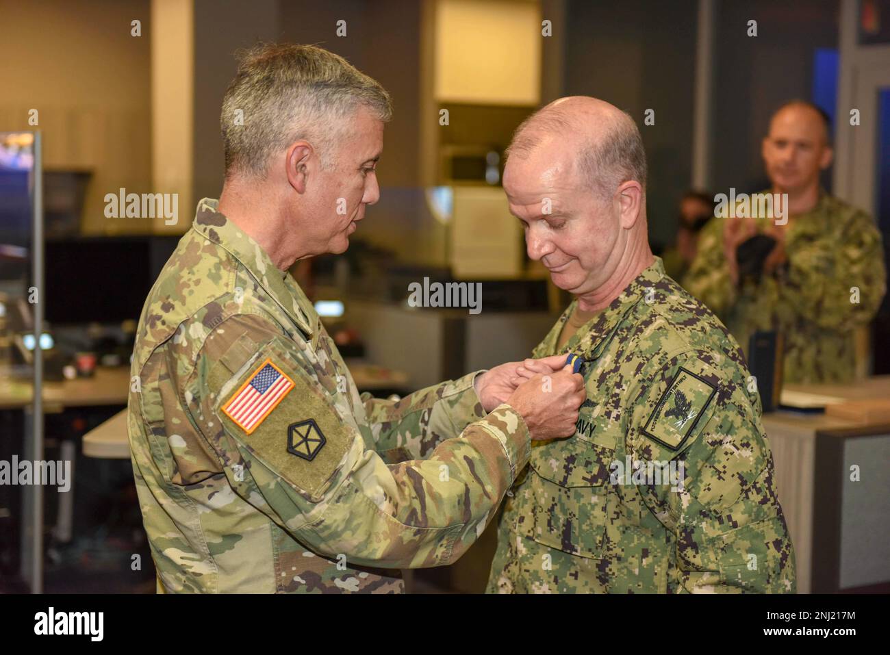 220804-N-XK809-1176 FORT GEORGE G. MEADE, Md. (Aug. 4, 2022) General Paul M. Nakasone, left, Commander, U.S. Cyber Command, Director, National Security Agency and Chief, Central Security Service, awards Vice Adm. Ross Myers, commander, U.S. Fleet Cyber Command/U.S. 10th Fleet, with a distinguished service medal during a change of command ceremony at the U.S. Fleet Cyber Command/U.S. 10th Fleet Headquarters. During the ceremony, Vice Adm. Craig Clapperton relieved Vice Adm. Ross Myers as commander of U.S. Fleet Cyber Command/U.S. 10th Fleet. Stock Photo