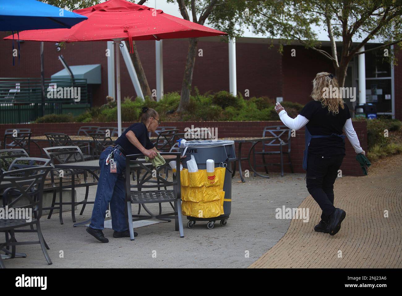 Jovita Solano (left) and Obdulia Hernandez (right) cleaning the tables and  chairs at the Google campus in Mountain View, Calif., on Wednesday, October  11, 2012. (Liz Hafalia/San Francisco Chronicle via AP Stock