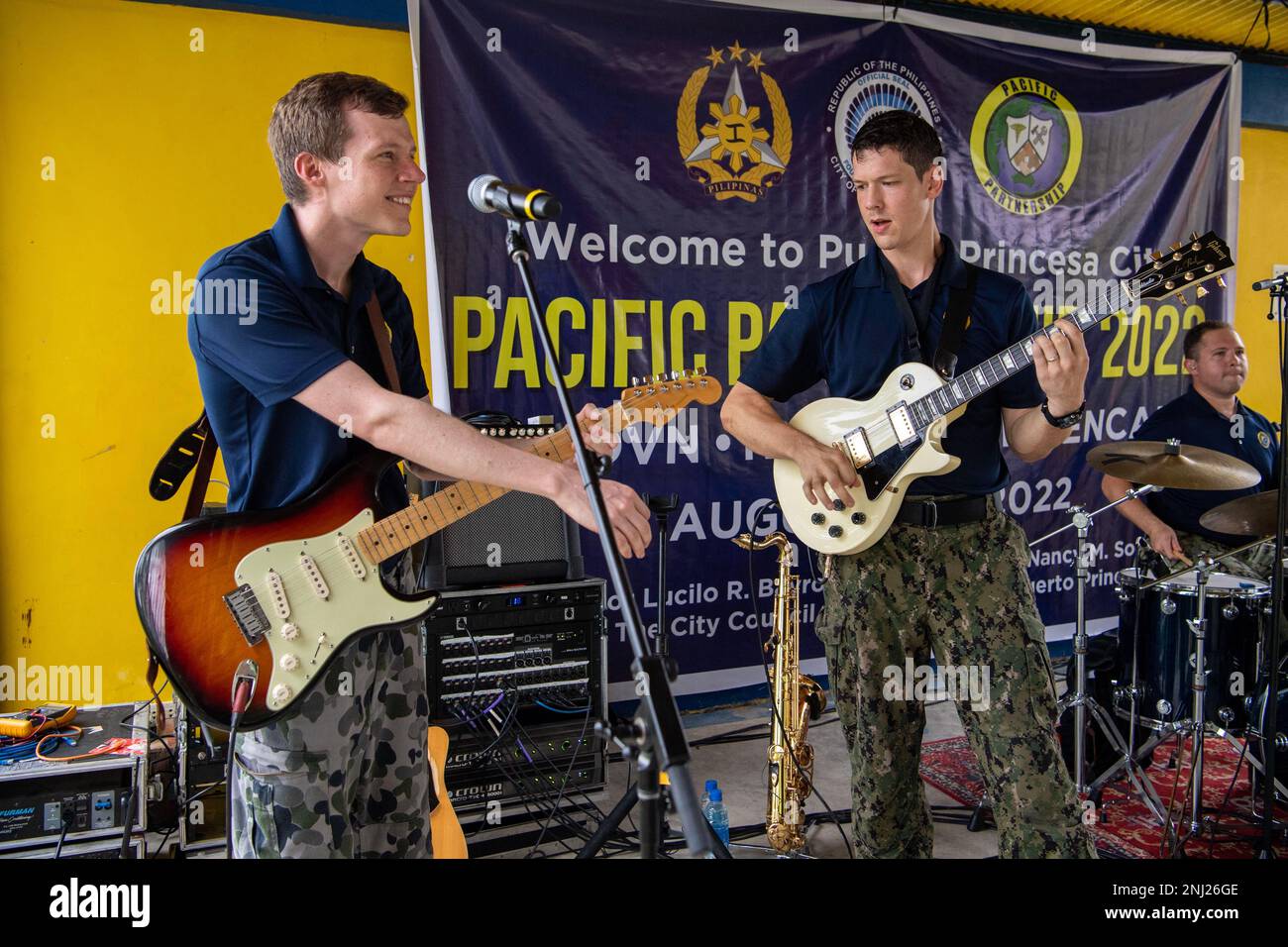 PUERTO PRINCESA, Philippines (Aug. 4, 2022) – Musician 3rd Class Samuel Detweiler, from Broadalbin, New York, right, and Able Body Seaman Philip Edey, a musician in the Royal Australian Navy Band, perform during a community outreach event at San Rafael High School during Pacific Partnership 2022. Now in its 17th year, Pacific Partnership is the largest annual multinational humanitarian assistance and disaster relief preparedness mission conducted in the Indo-Pacific. Stock Photo