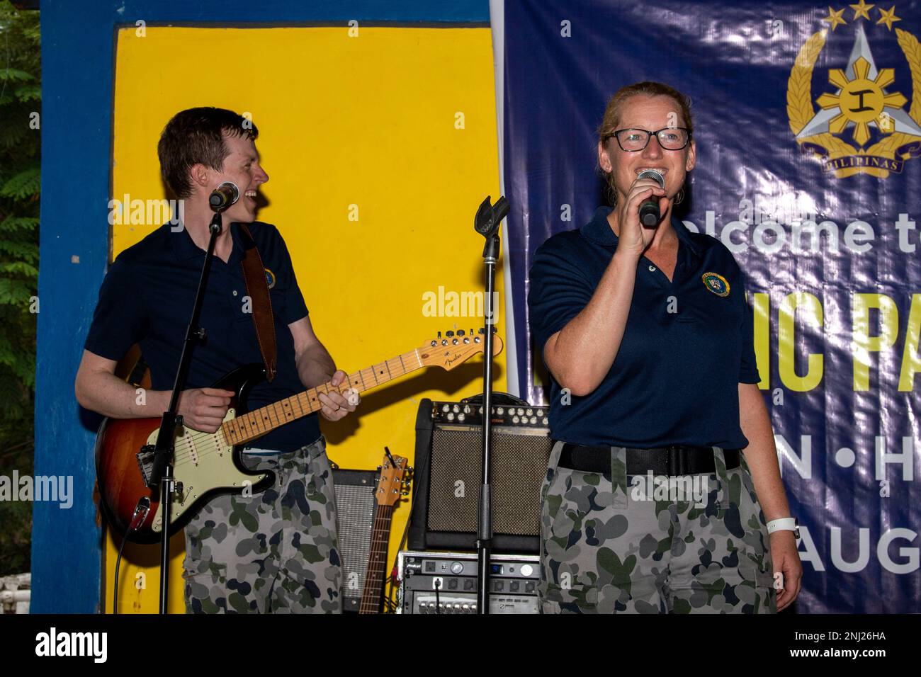 PUERTO PRINCESA, Philippines (Aug. 4, 2022) – Royal Australian Navy Able Body Seaman Claire Donoghue, right, and Able Body Seaman Philip Edey, musicians in the Royal Australian Navy Band, perform with members of the U.S. Pacific Fleet Band during a community outreach event at San Rafael High School during Pacific Partnership 2022. Now in its 17th year, Pacific Partnership is the largest annual multinational humanitarian assistance and disaster relief preparedness mission conducted in the Indo-Pacific. Stock Photo