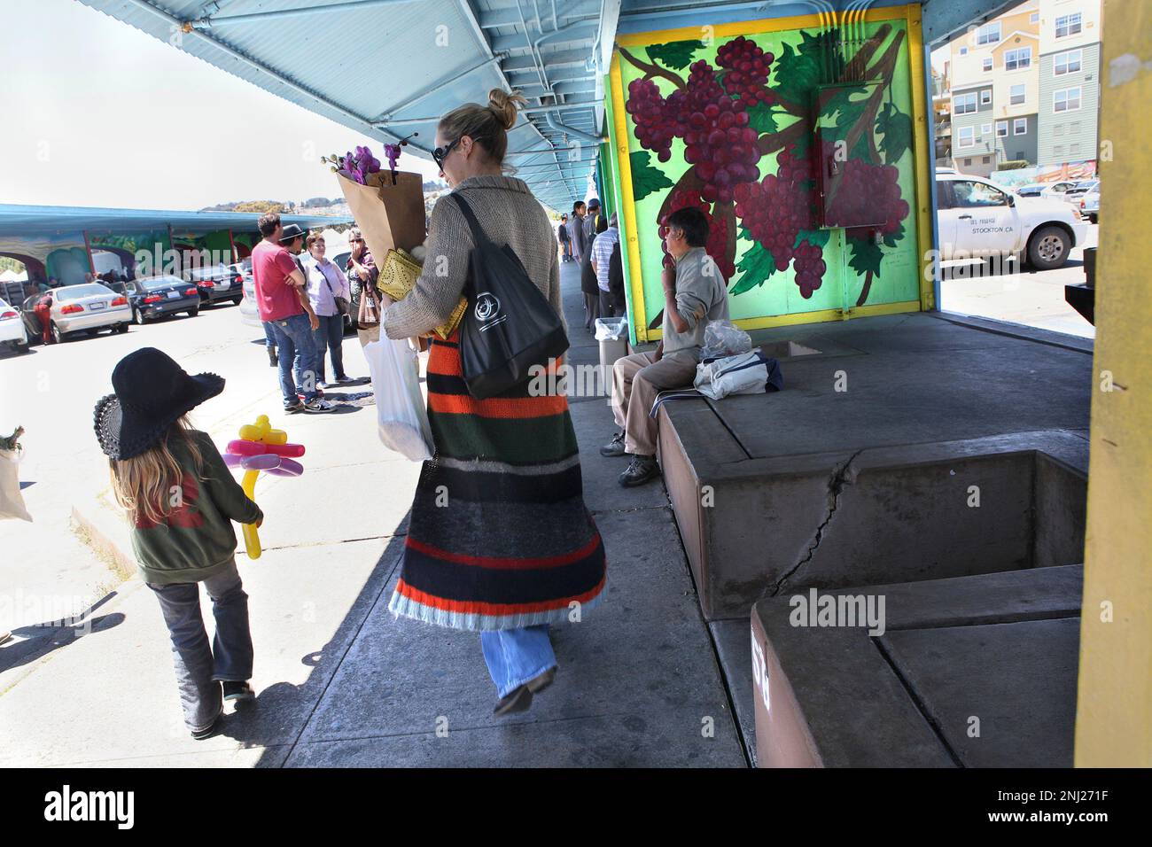 Collier Hancock (middle) and her four year old daughter Ruby Hancock (left)  just moved in the neighborhood from Texas and enjoying their time at  Alemany Farmer's Market in San Francisco, Calif., on