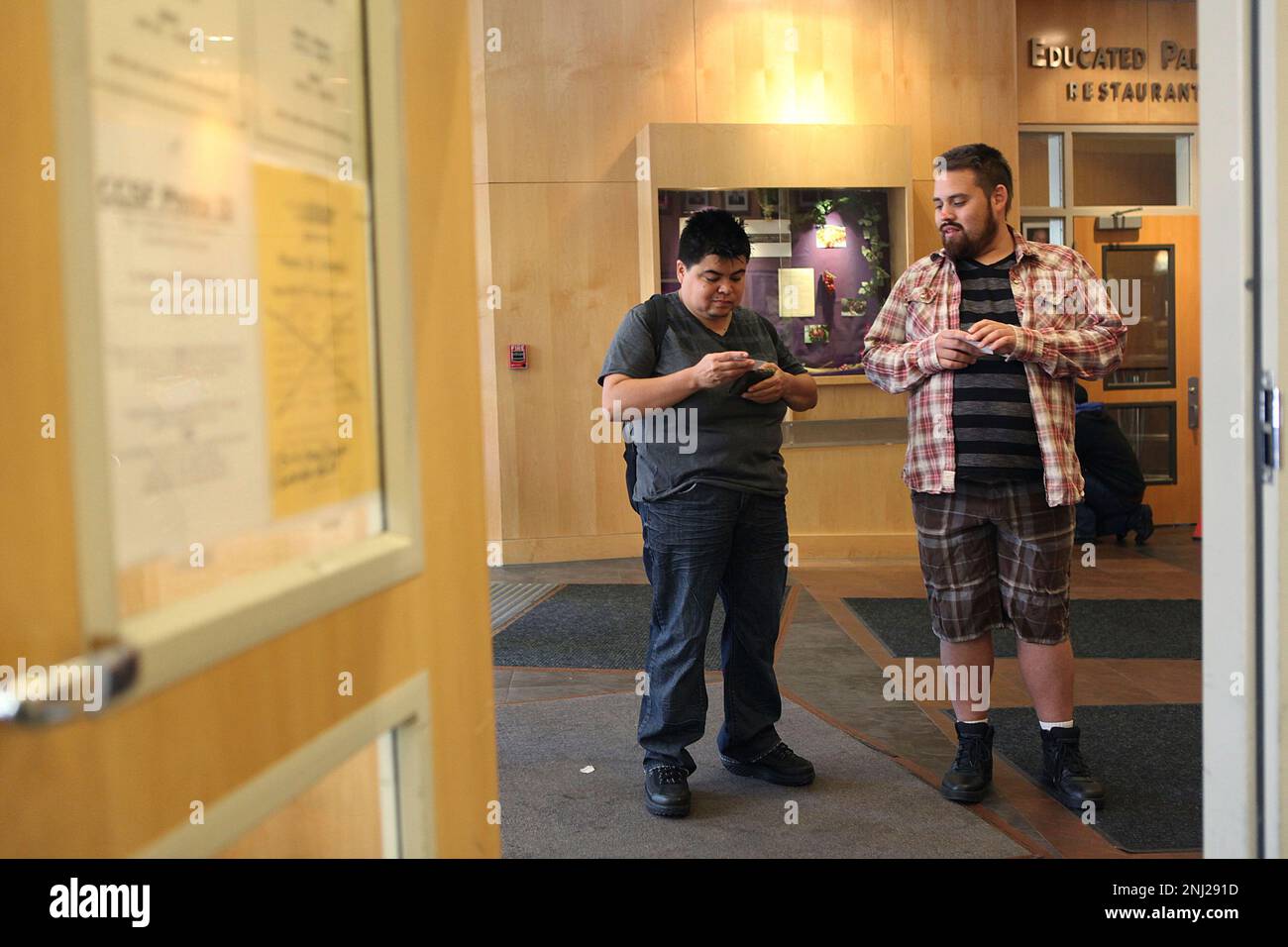 Alicia Salazar (left), 34 years old, and Jacob Sockness (right), 29 years  old, heading into the admissions office of the City College of SF Downtown  campus in San Francisco, California, on Wednesday