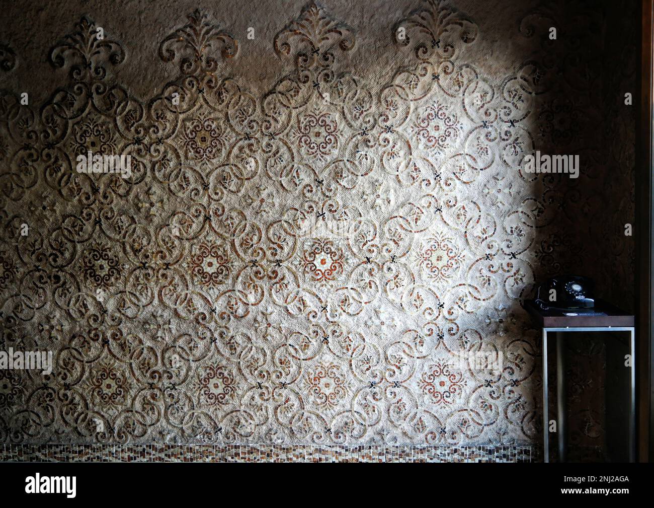 Tokyo, Japan - Sept, 2017: Rustic mosaic wall pattern with light and shadow and telephone National museum of tokyo Stock Photo