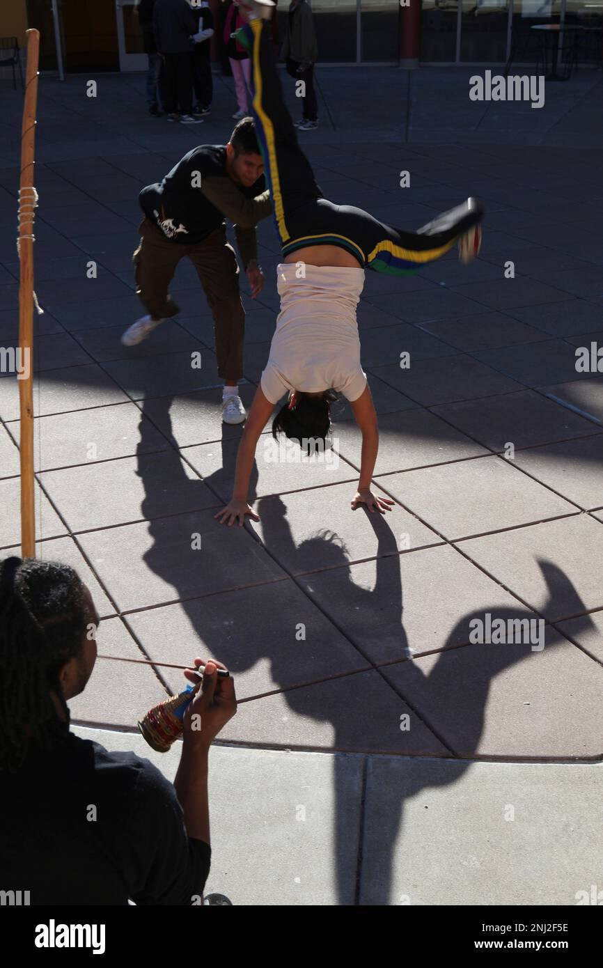 Vanessa Quezada playing capoeira with Jian Giannini (top) as Jarrel Phillips (bottom left) plays