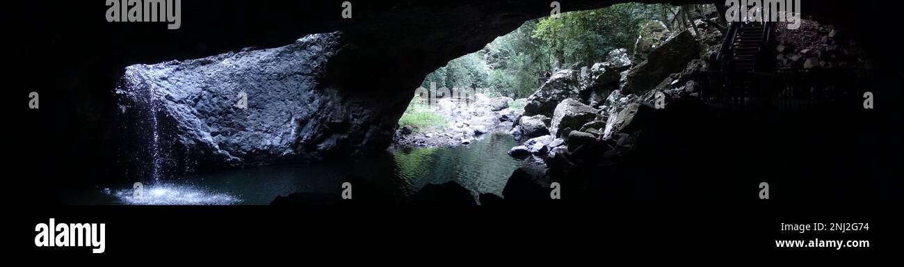 Panoramic shot of Natural Bridge, a waterfall in a cave. Springbook National Park, Australia Stock Photo