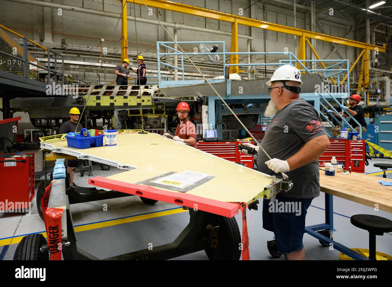 A 573rd Aircraft Maintenance Squadron crew prepares to install a wing