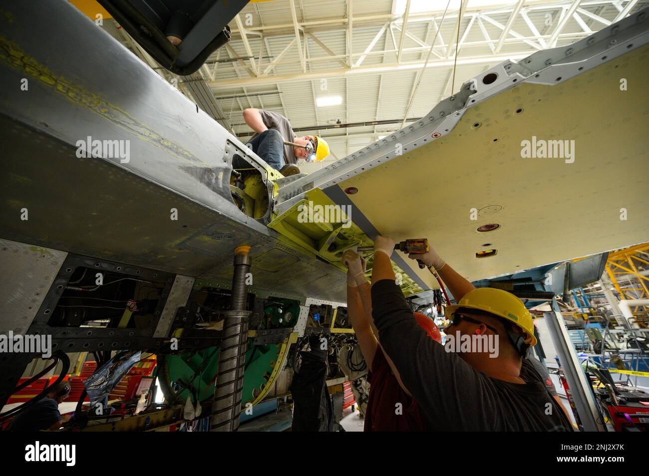 A 573rd Aircraft Maintenance Squadron crew installs a wing onto an F16