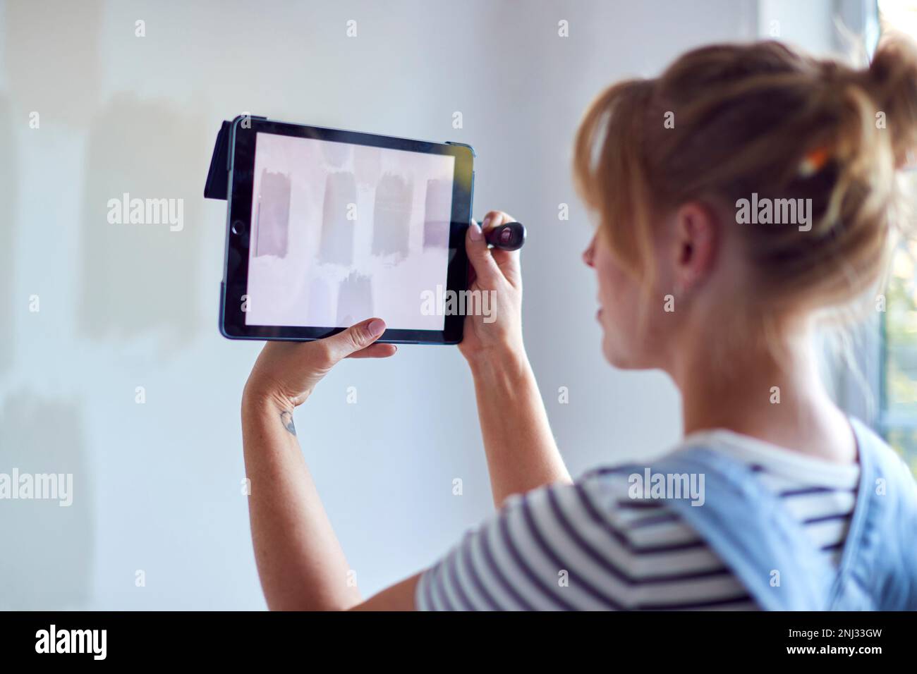 Woman With Digital Tablet Decorating Room In House Comparing Tester ...