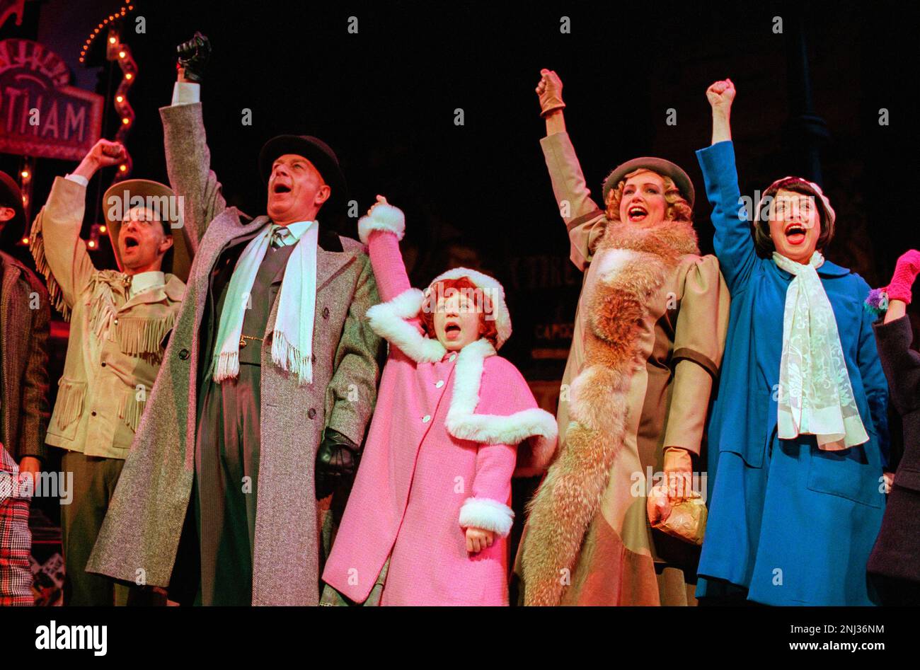 from 2nd left: Kevin Colson (Oliver ‘Daddy’ Warbucks), Charlene Barton (Annie), Kate Normington (Grace Farrell), Louisa McCarthy (Cecille) in ANNIE at the Victoria Palace Theatre, London SW1  01/10/1998  book: Thomas Meehan  music: Charles Strouse  lyrics: Martin Charnin  set design: Kenneth Foy  costumes: Theoni V Aldredge  lighting: Ken Billington  original choreography: Peter Gennaro  director: Martin Charnin Stock Photo