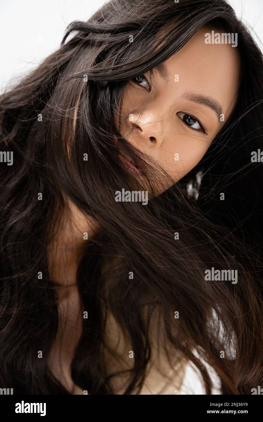 portrait of asian woman with shiny brunette hair looking at camera isolated  on white,stock image Stock Photo - Alamy