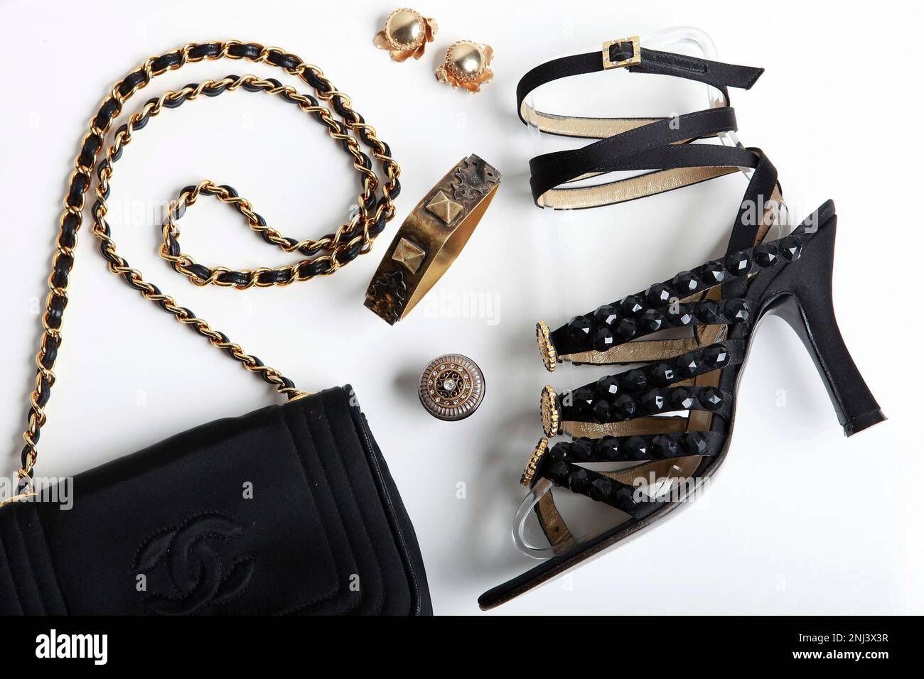 A Chanel chain-strap purse, vintage gold clips, costume ring and bangle,  and Gianni Versace sandals at Labels Acccessories in Berkeley, to pair with a  Roberto Cavalli dress. (Liz Hafalia/San Francisco Chronicle via