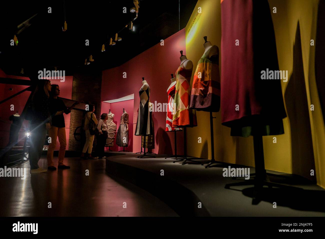 Several people look at some of the designs that make up the exhibition  'Sybilla. El hilo invisible', at La Sala Canal de Isabel II, on October 16,  2022, in Madrid (Spain). This