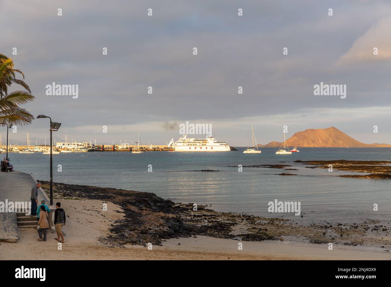 The bay of Corralejo with a view of the port and, in the distance, the island of wolves (Isla de los Lobos), Fuerteventura. Stock Photo