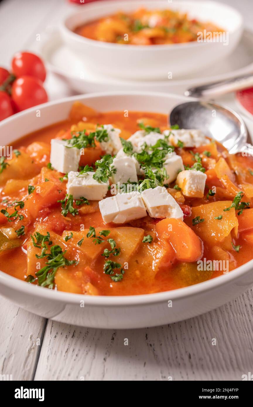 Vegetable soup with cabbage and feta cheese on a plate Stock Photo