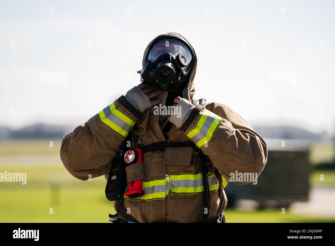 U.S. Air Force Staff Sgt. Dominic Pavlich, 6th Civil Engineer Squadron firefighter, prepares his protective equipment before engaging in an aircraft rescue and firefighting proficiency training at MacDill Air Force Base, Florida, Aug. 5, 2022. ARFF training helps prepare Air Force firefighters to manage compromised aircraft in emergency situations. Stock Photo