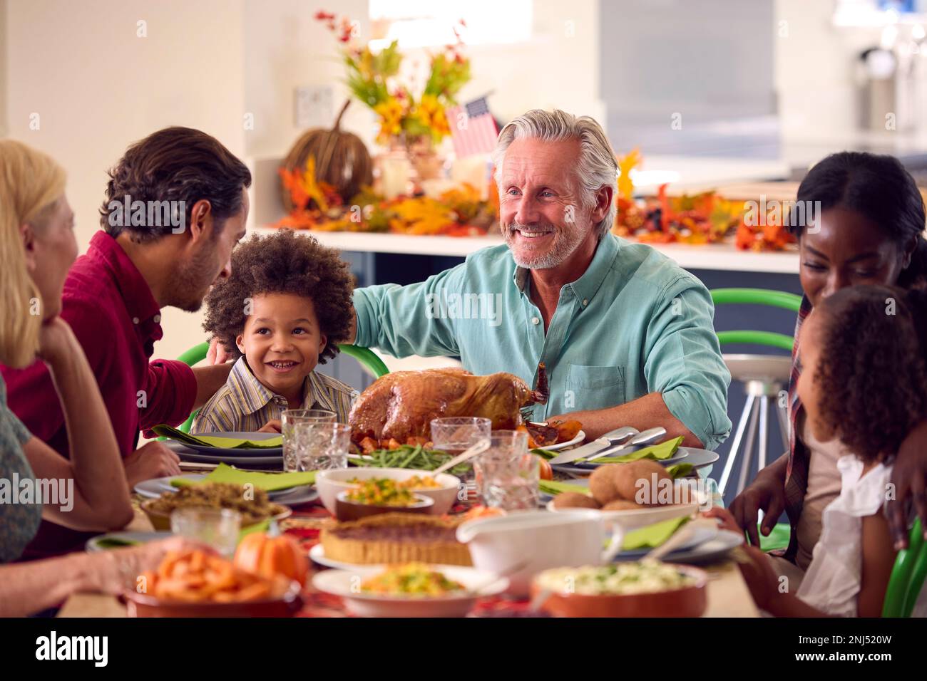 Multi-Generation Family Celebrating Thanksgiving At Home Eating Meal