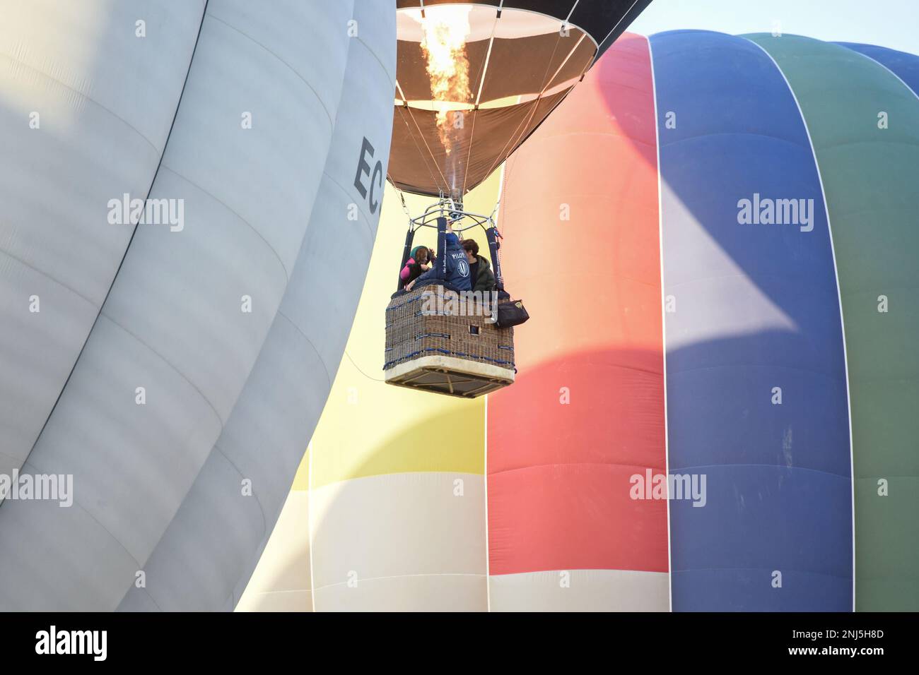 Several people ride on the barge of a zeppelin in flight during the Hot