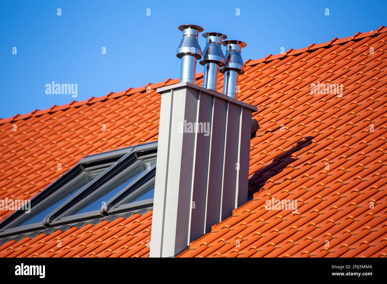 Beautiful new stainless steel chimney on the roof of a residential