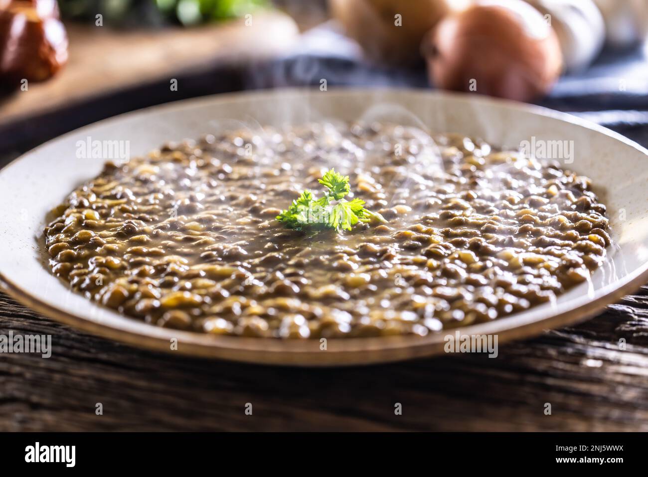 A bowl full of lentil soup with potatoes. Healthy legume food. Stock Photo