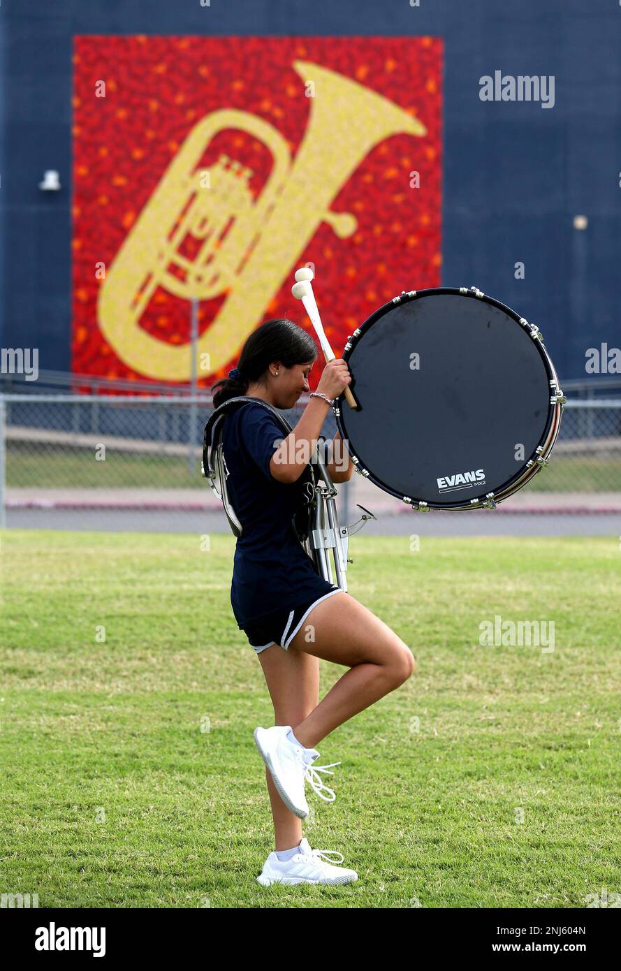 Sofia Diosdado, 14, lifts her drum to join Edinburg North marching band