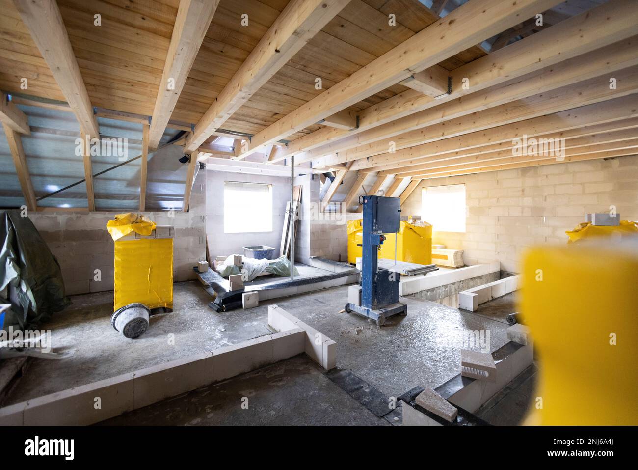 Construction site inside a single-family house - upper floor with wooden roof beams Stock Photo