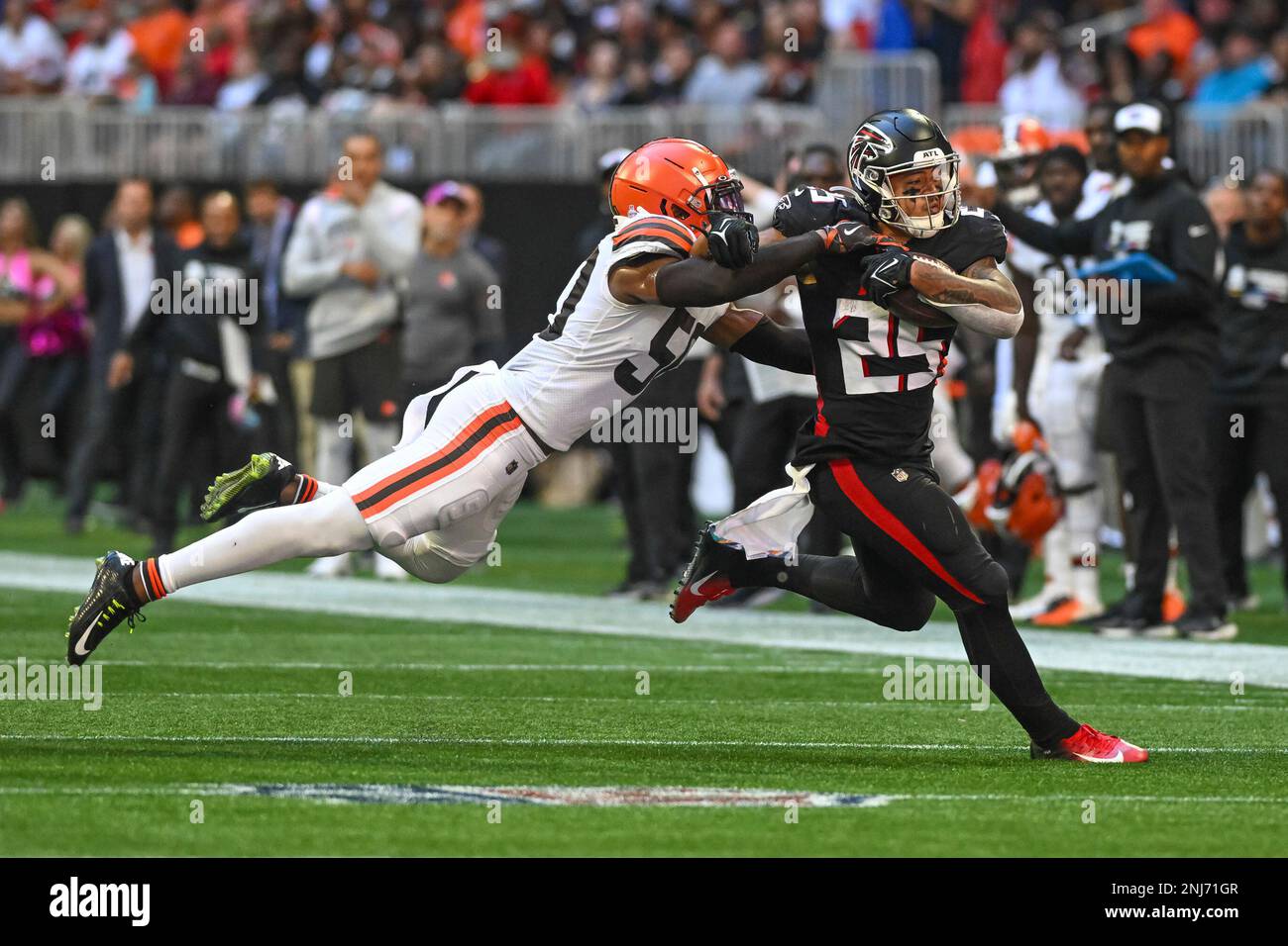 ATLANTA, GA - OCTOBER 02: Atlanta Falcons running back Tyler Allgeier (25)  is tackled by Cleveland Browns linebacker Jacob Phillips (50) during the  NFL game between the Cleveland Browns and Atlanta Falcons